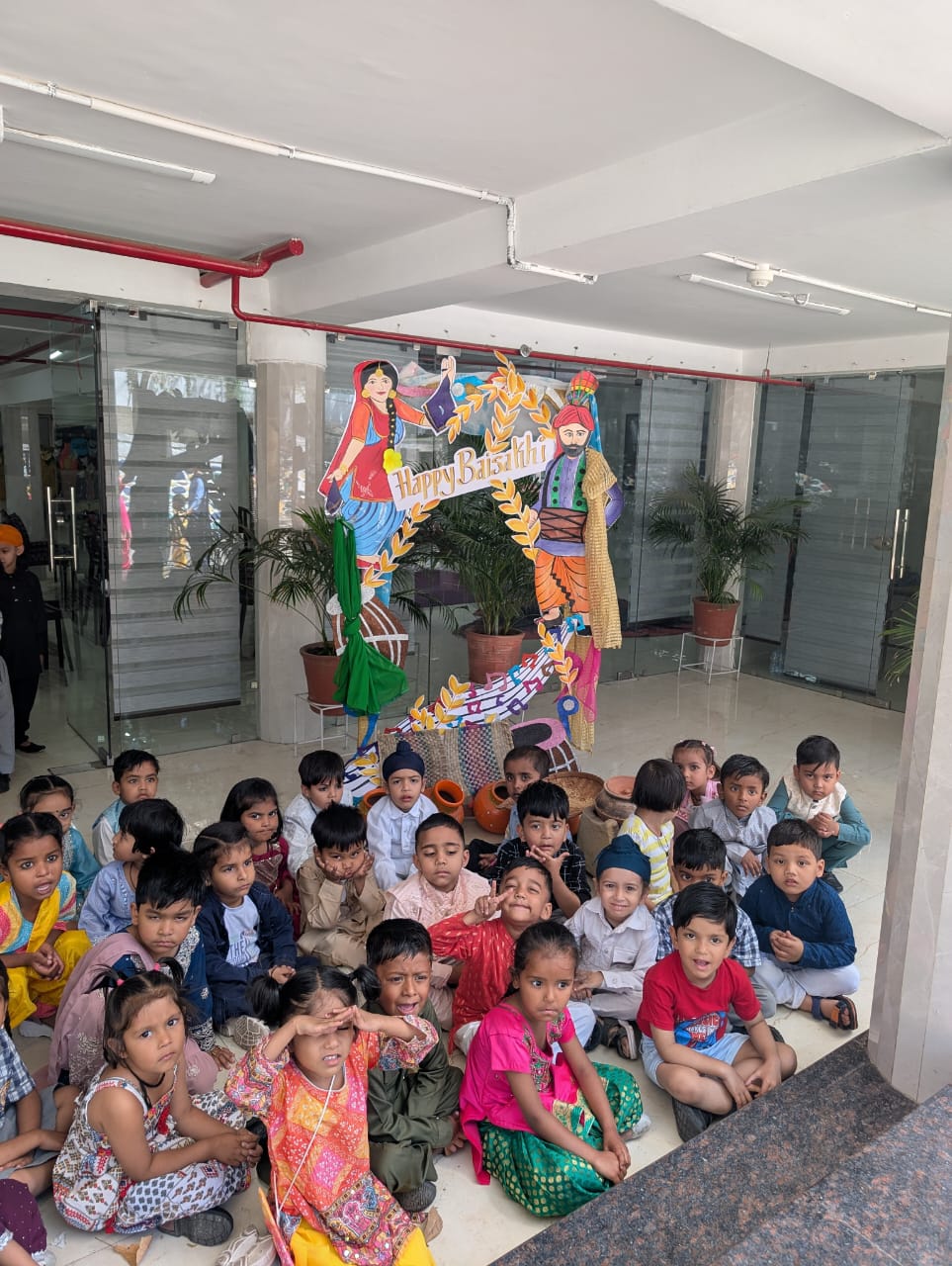 Group of students sitting in front of Baisakhi decor